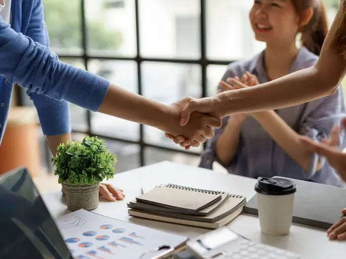 Handshake at an office meeting, showing CityBiz Portal helping local businesses find partners and new clients